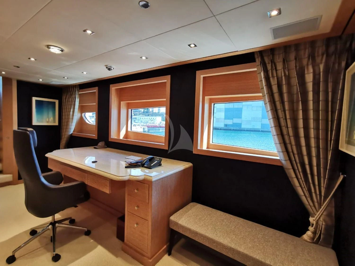 a room with a desk and a tv aboard FRIENDSHIP Yacht for Charter
