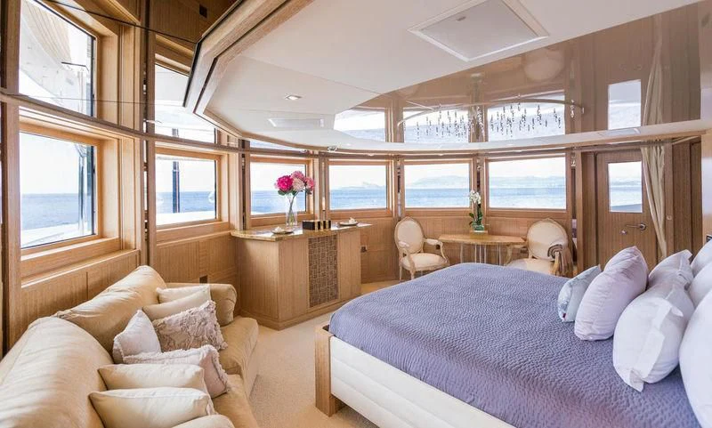 a bedroom with a bed and a table aboard FRIENDSHIP Yacht for Charter