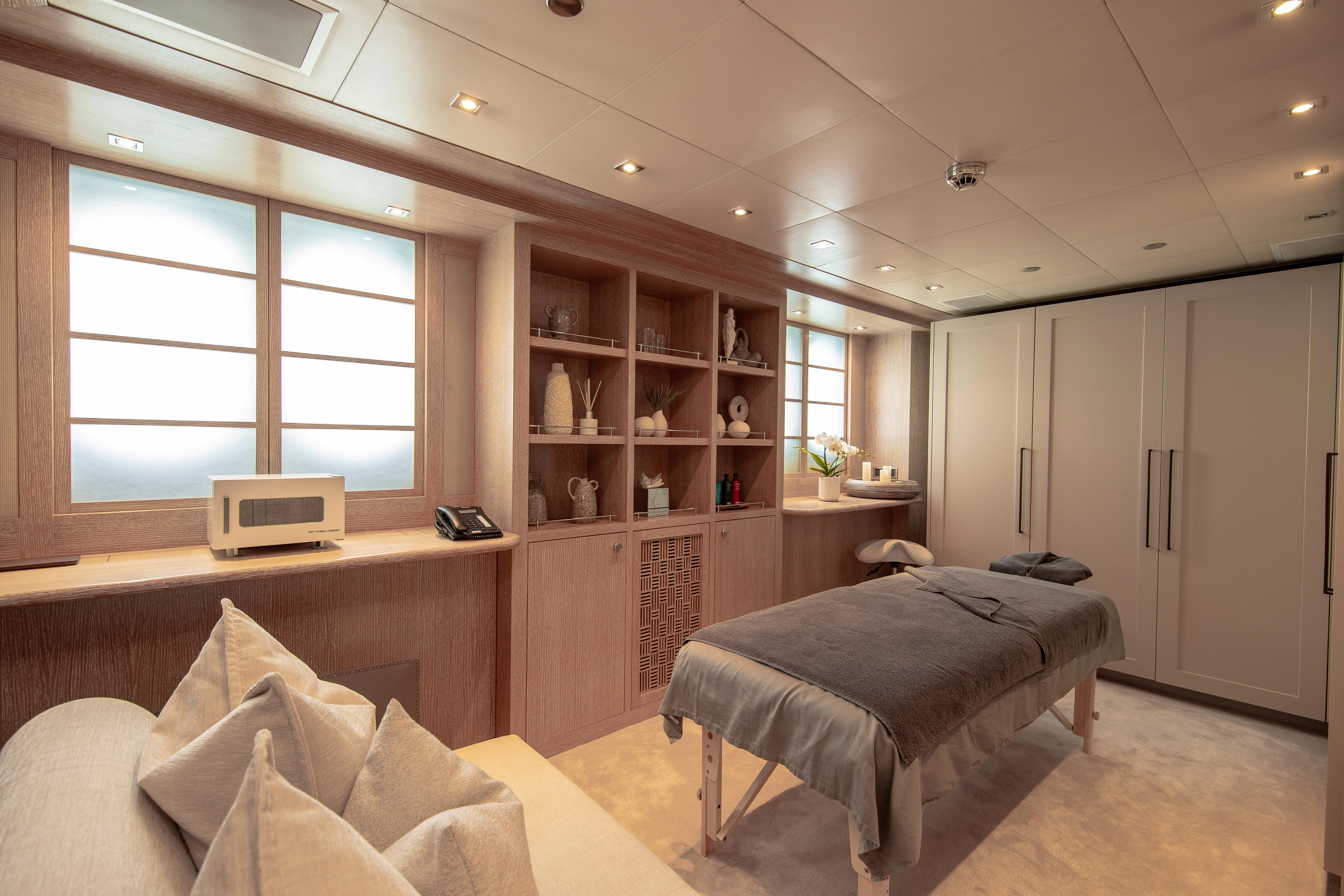 a bedroom with a bed and a desk aboard FRIENDSHIP Yacht for Charter