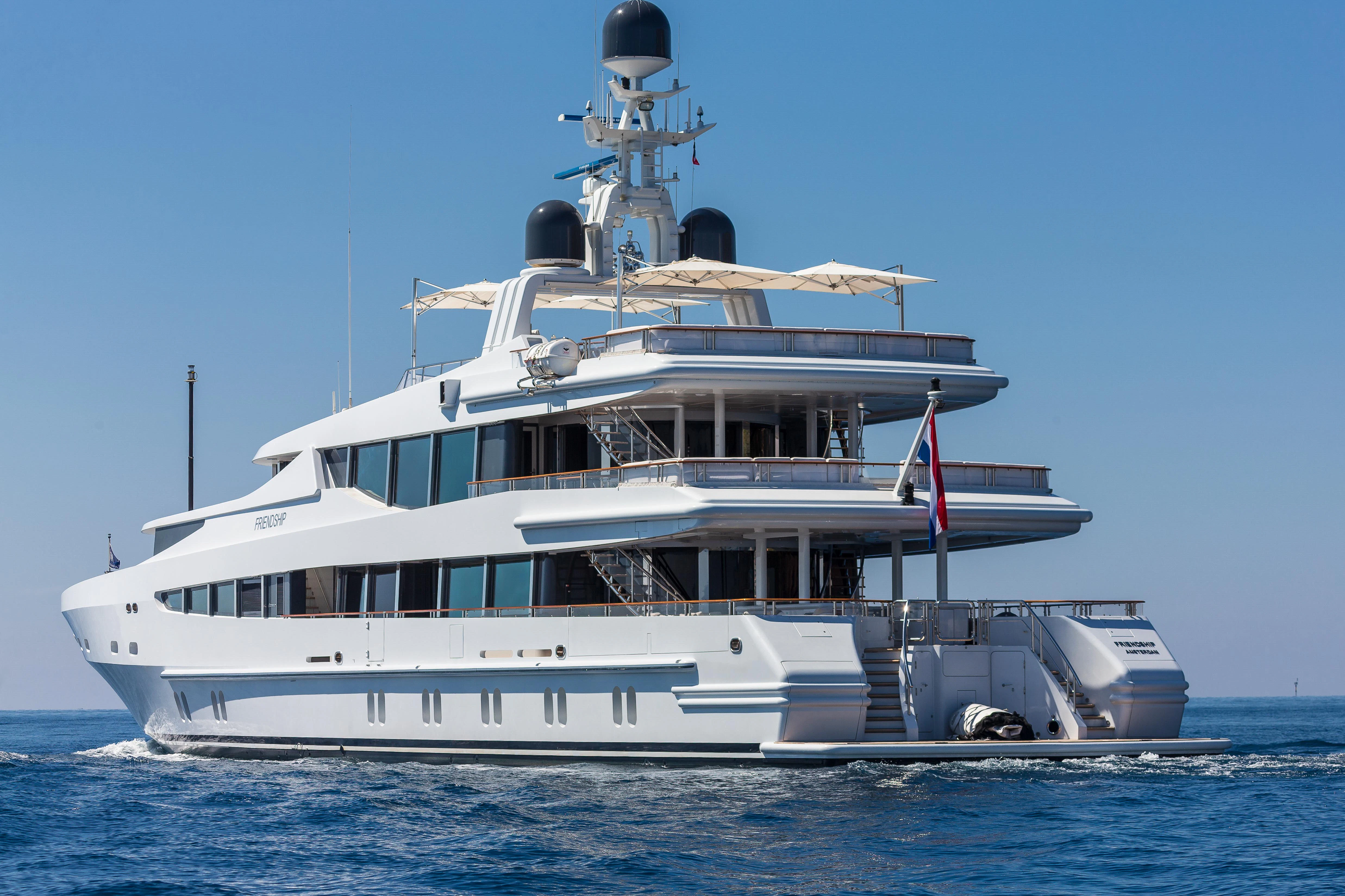 a large white boat in the water aboard FRIENDSHIP Yacht for Charter