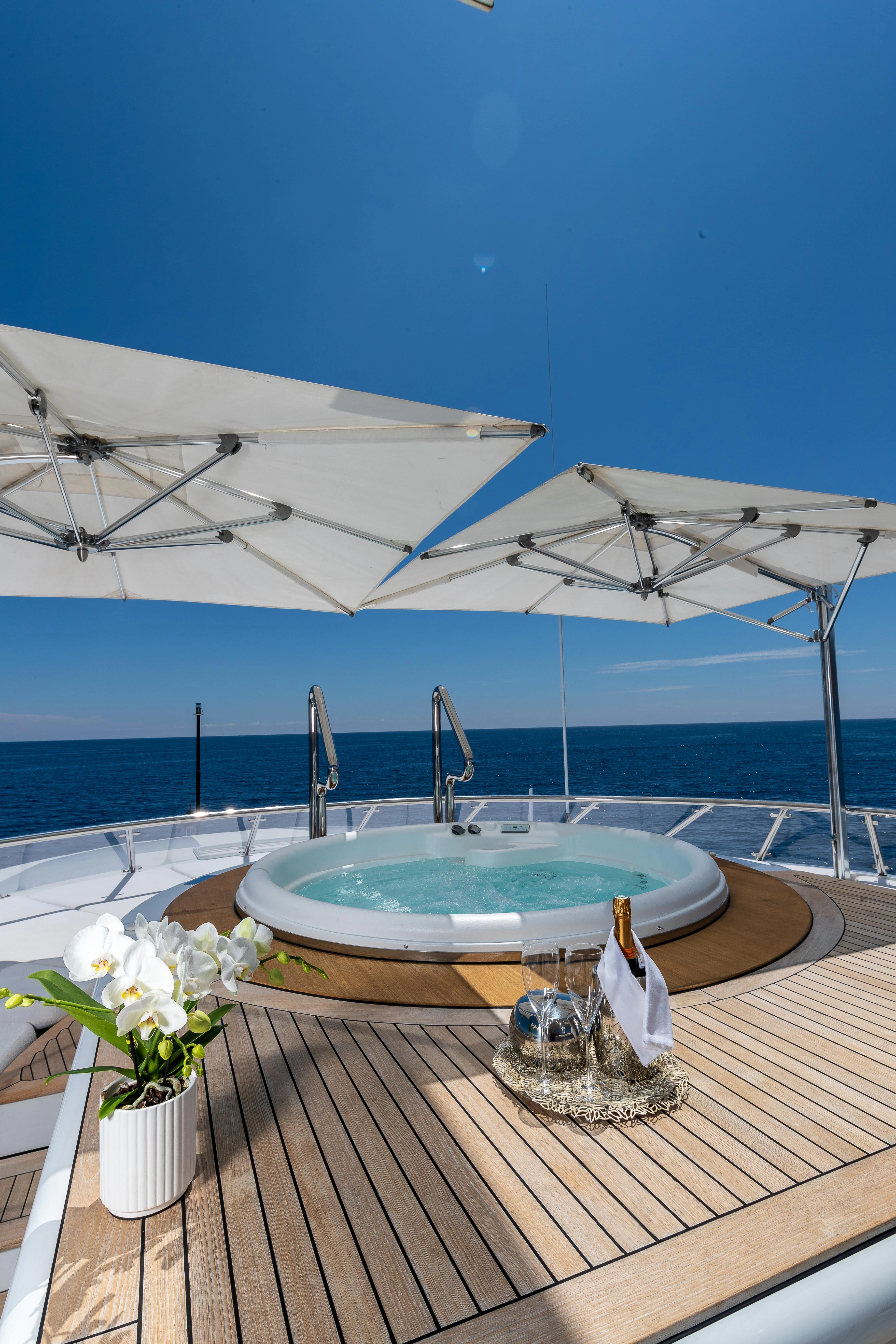 a pool with a table and chairs by the water aboard FRIENDSHIP Yacht for Charter