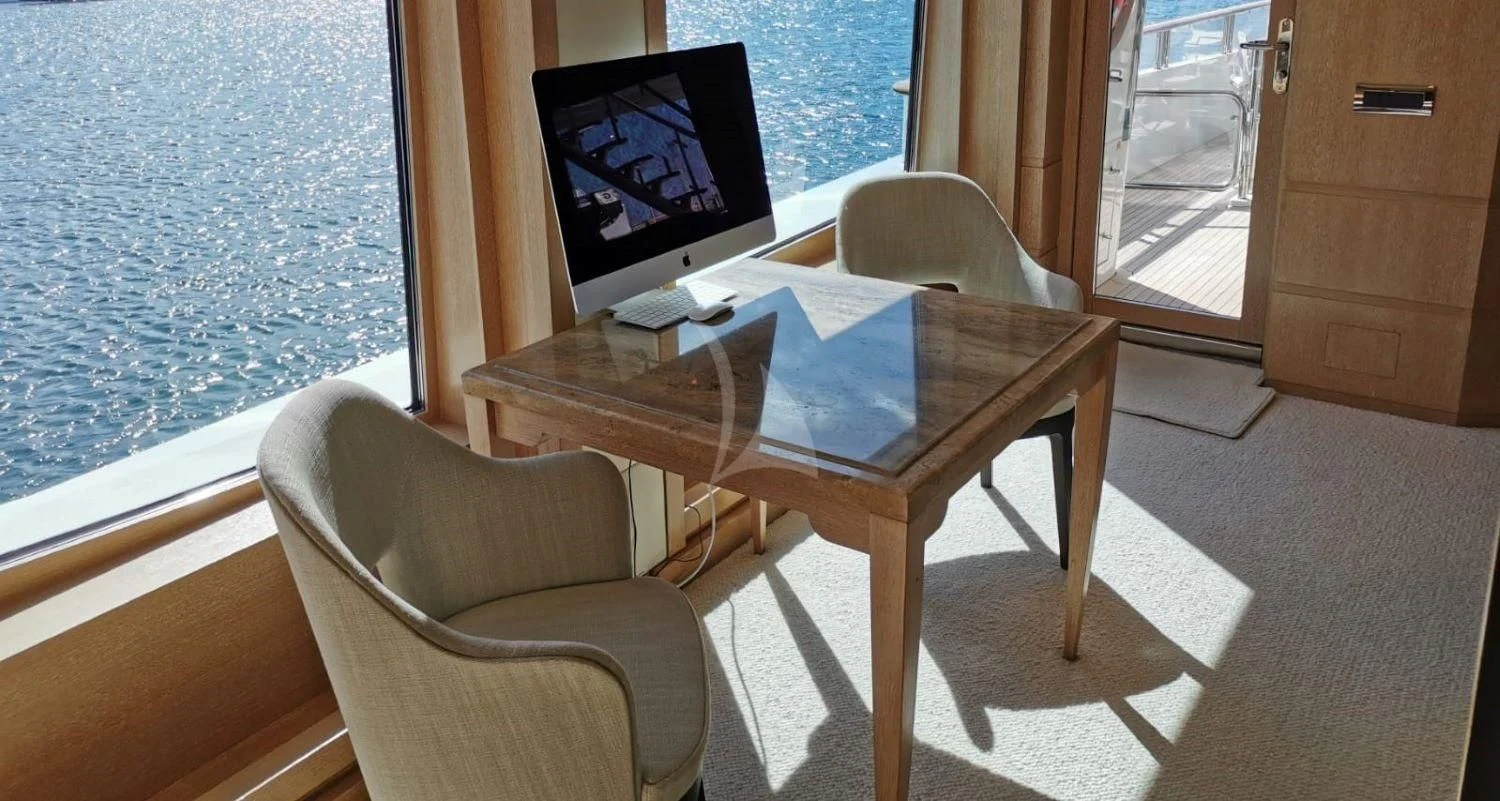 a table and chairs in a room aboard FRIENDSHIP Yacht for Charter