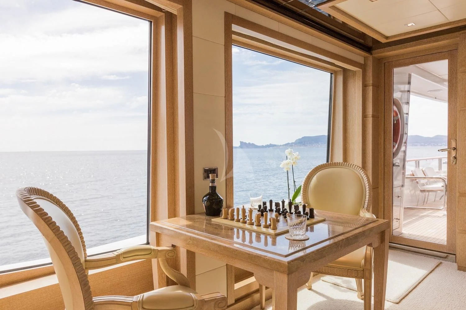 a table with chess pieces on it aboard FRIENDSHIP Yacht for Charter