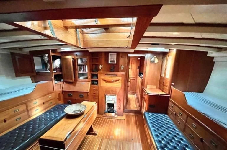 a cabin with a table and chairs aboard SO FONG Yacht for Sale