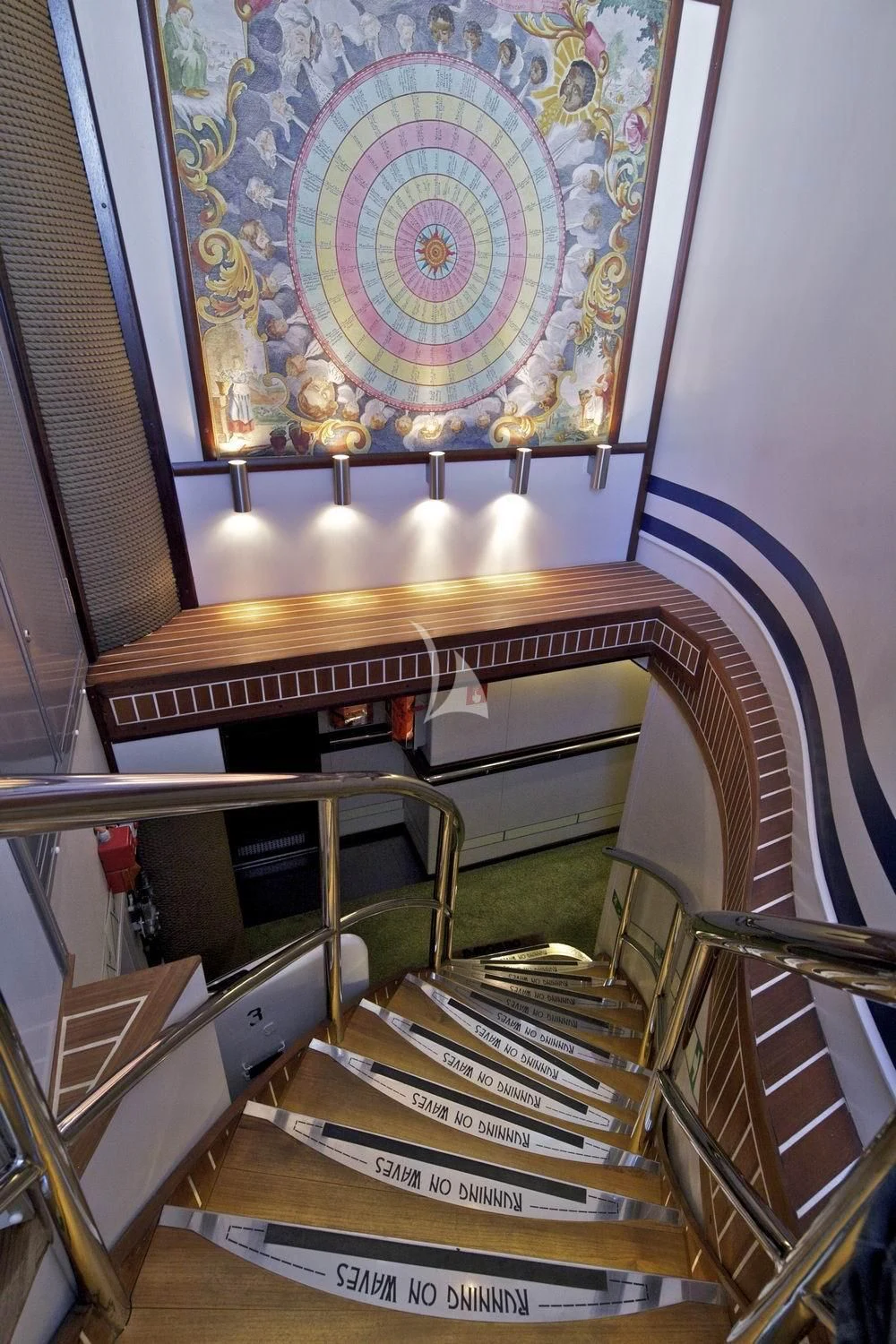 a staircase with a stained glass window aboard RUNNING ON WAVES Yacht for Charter