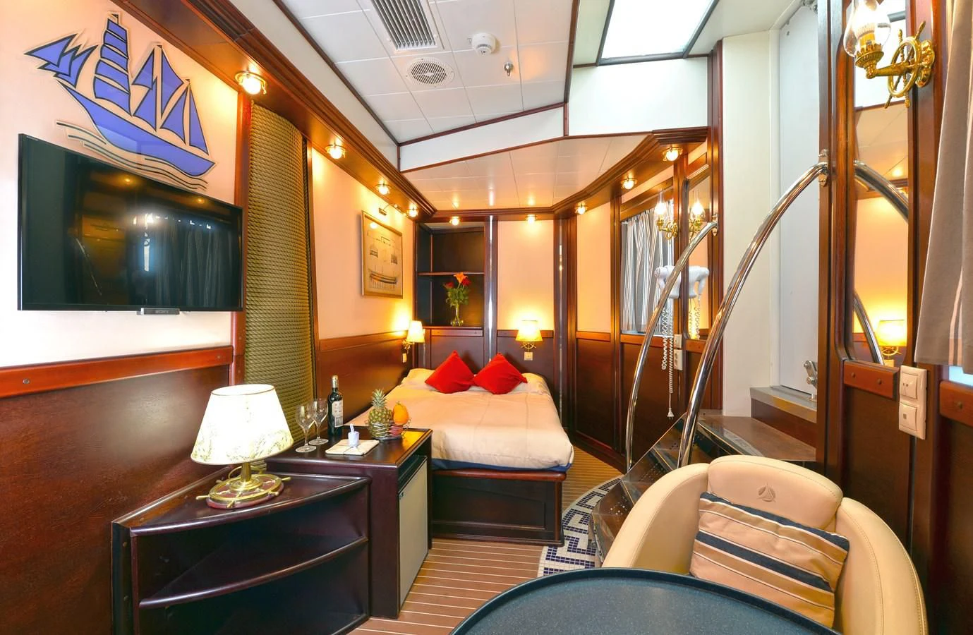 a room with a bed and a desk aboard RUNNING ON WAVES Yacht for Charter
