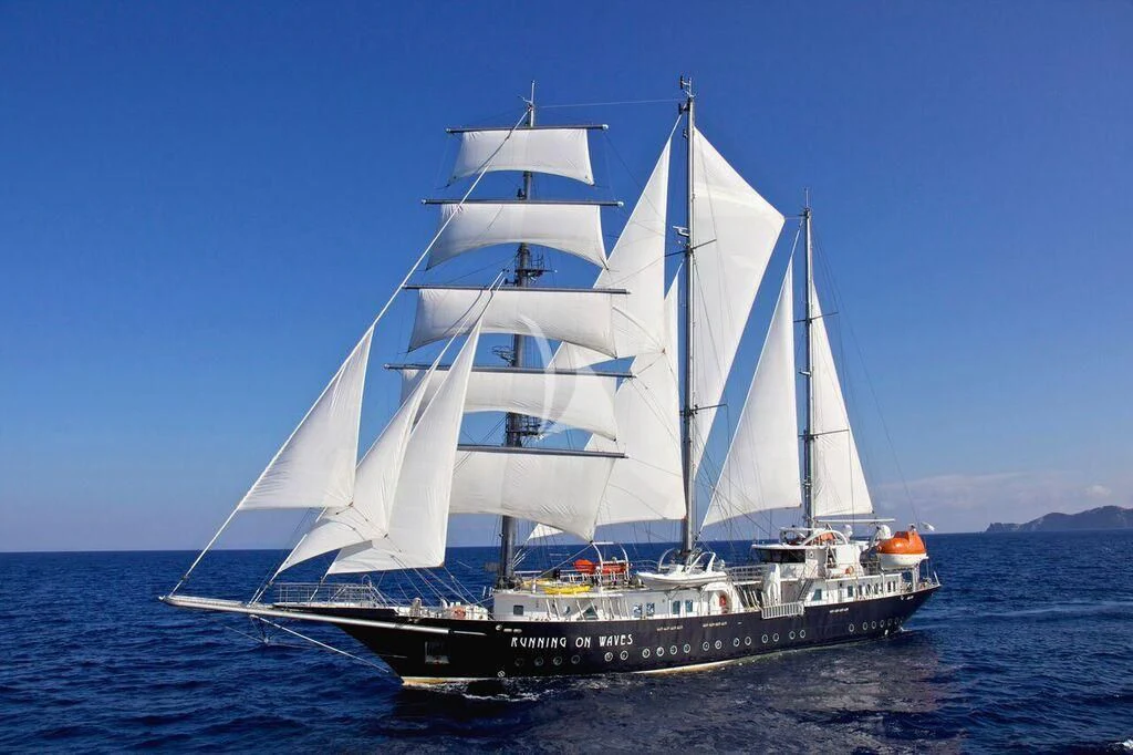 a white boat on the water aboard RUNNING ON WAVES Yacht for Charter