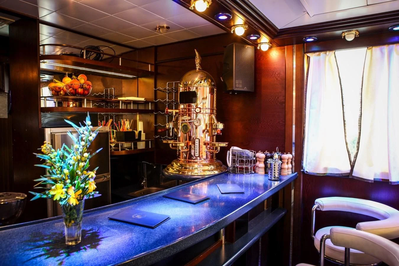 a restaurant with a table and chairs aboard RUNNING ON WAVES Yacht for Charter