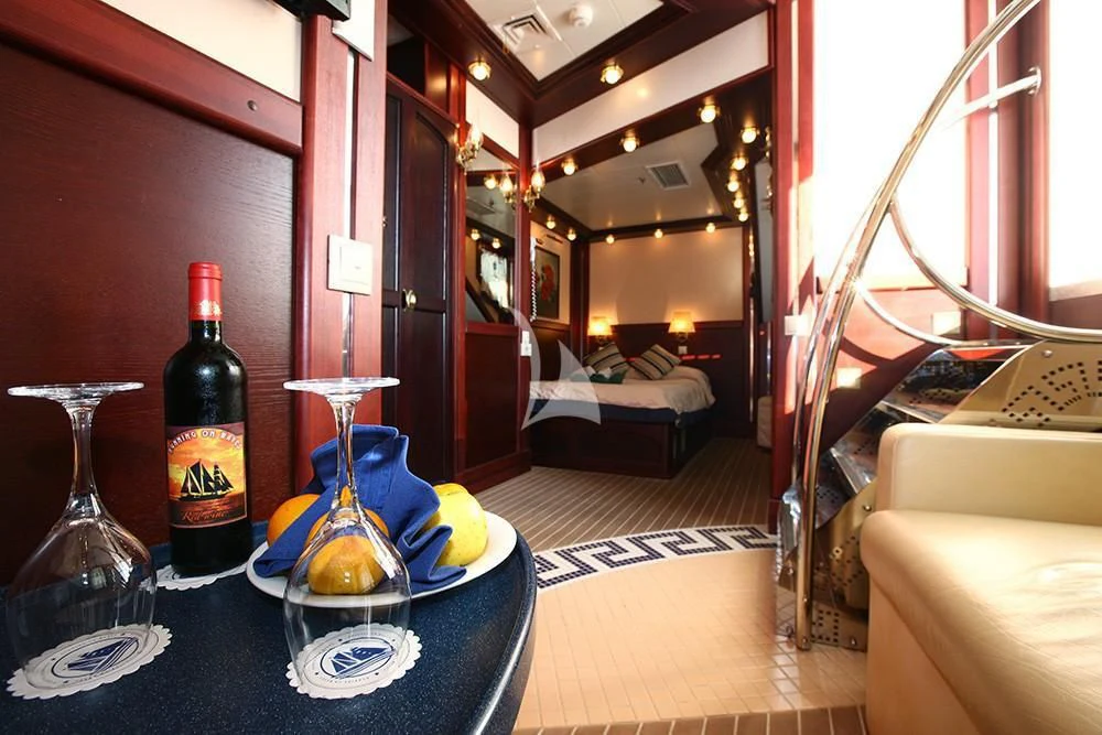 a room with a table and chairs aboard RUNNING ON WAVES Yacht for Charter