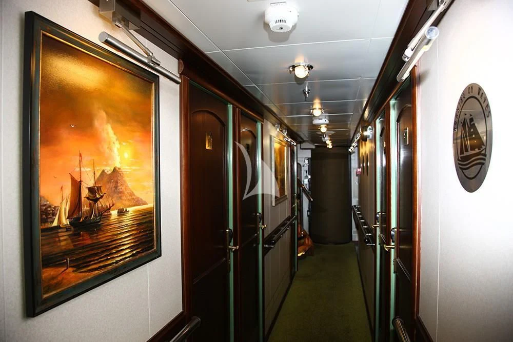 a hallway with a painting on the wall aboard RUNNING ON WAVES Yacht for Charter