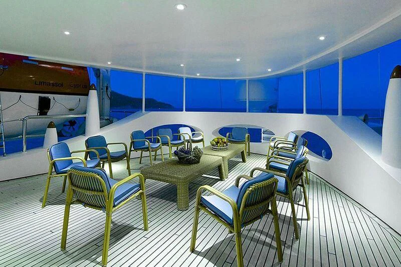 a room with tables and chairs aboard RUNNING ON WAVES Yacht for Charter