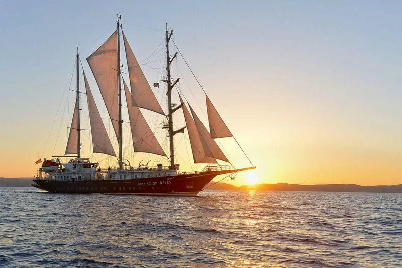a sailboat in the water aboard RUNNING ON WAVES Yacht for Charter