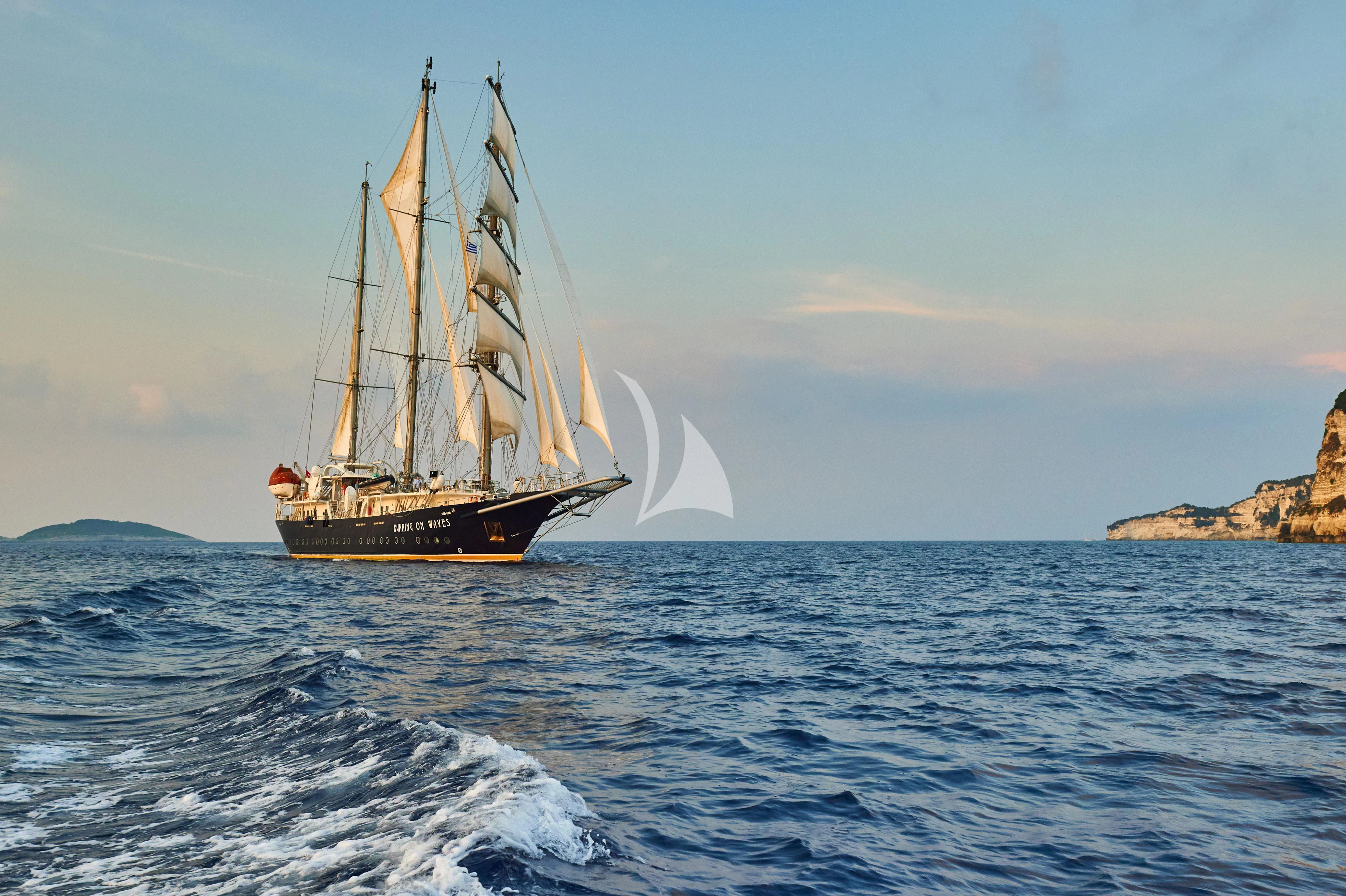 a sailboat in the water aboard RUNNING ON WAVES Yacht for Charter