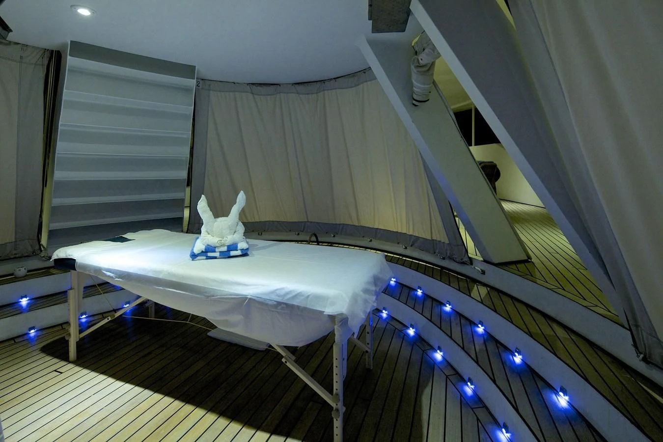 a white room with a white table and a white table with a white cloth on it aboard RUNNING ON WAVES Yacht for Charter