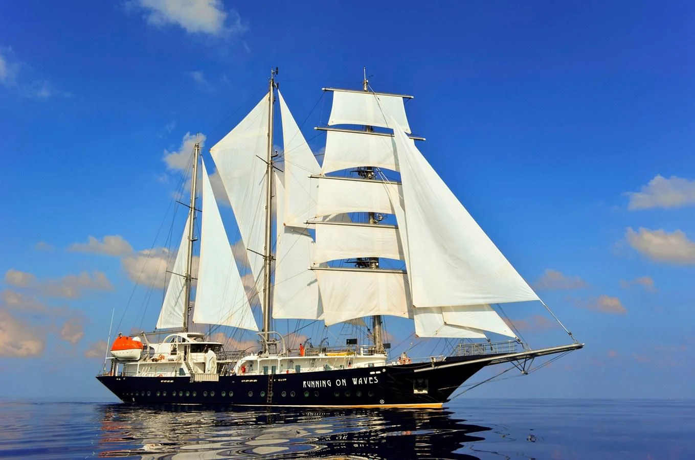 a large boat in the water aboard RUNNING ON WAVES Yacht for Charter