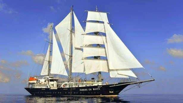 a large white boat aboard RUNNING ON WAVES Yacht for Charter