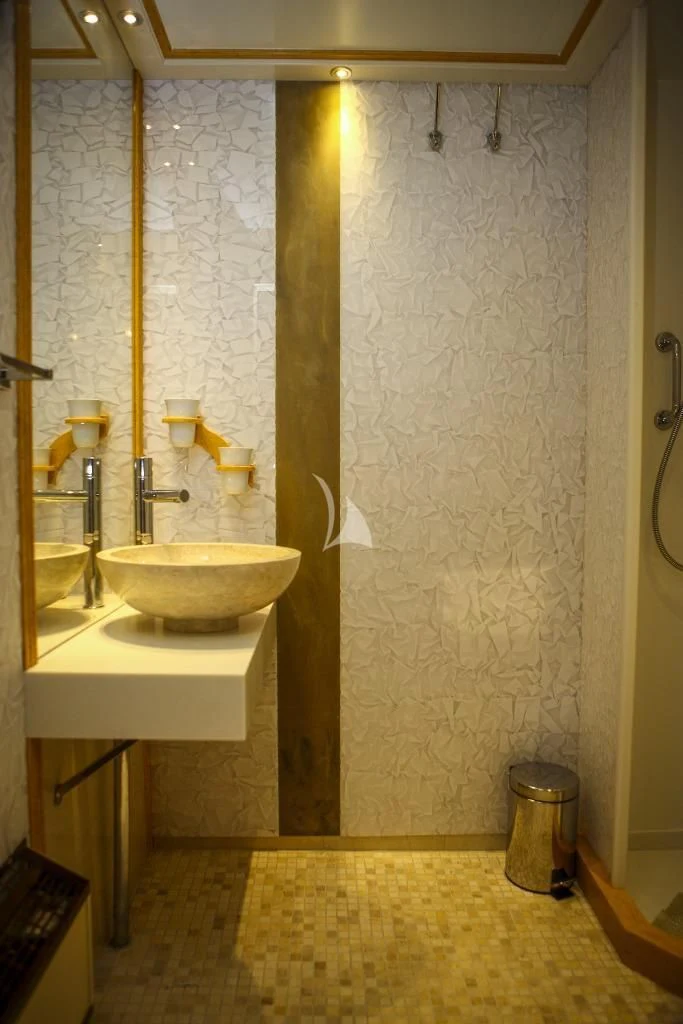 a bathroom with a sink and a mirror aboard RUNNING ON WAVES Yacht for Charter