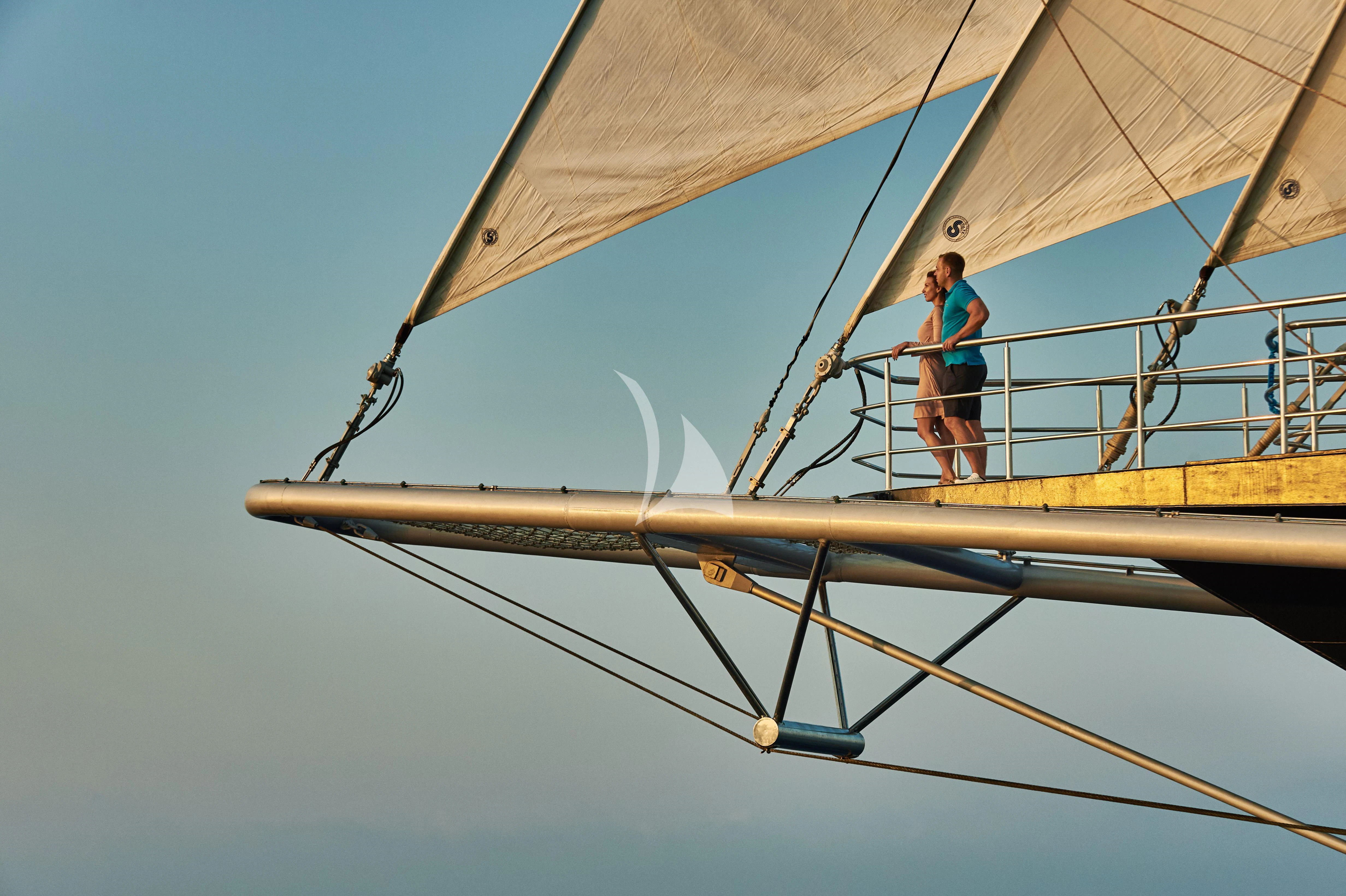 a person standing on a large sailboat aboard RUNNING ON WAVES Yacht for Charter