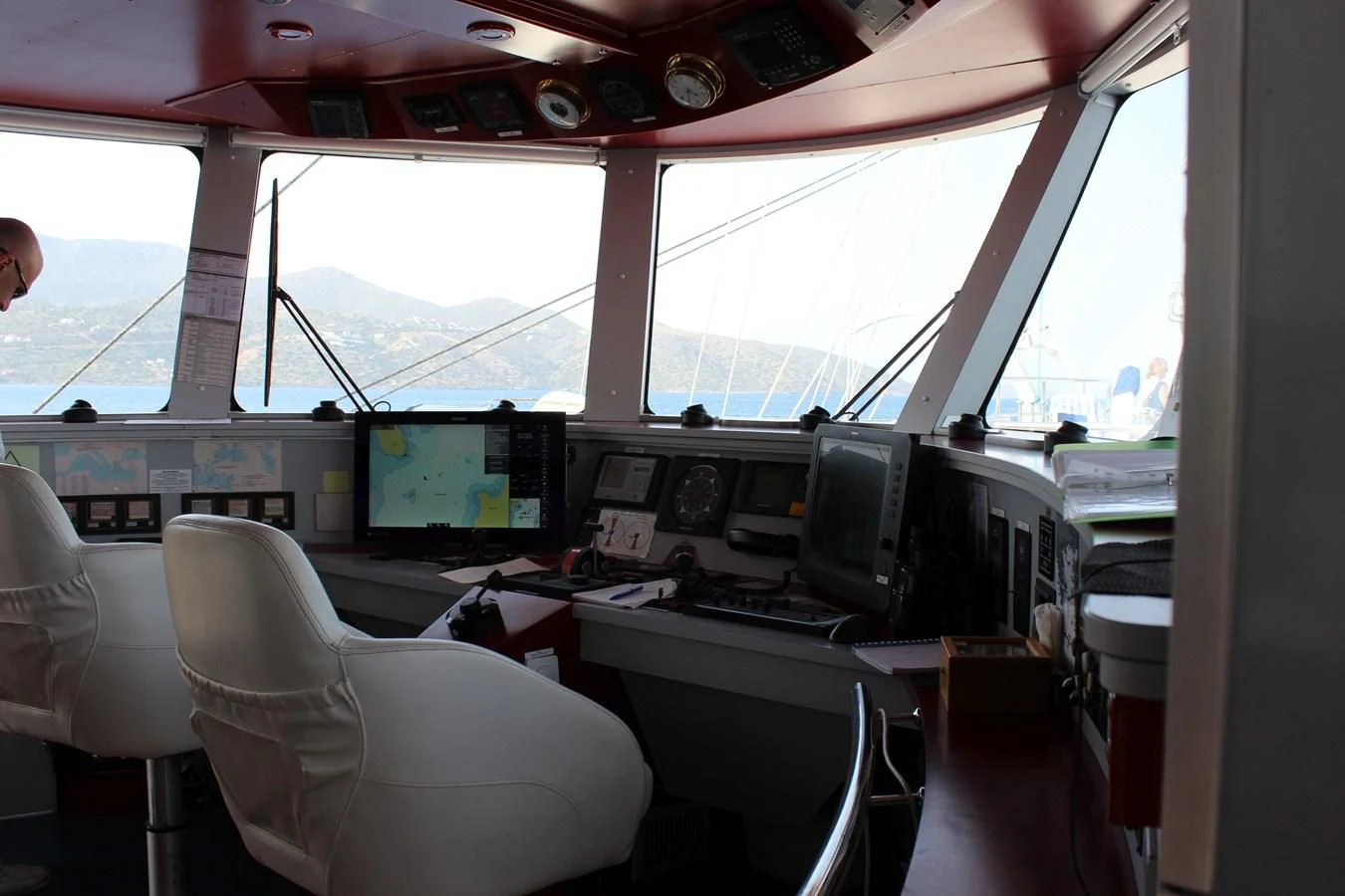 inside of a vehicle with monitors and monitors aboard RUNNING ON WAVES Yacht for Charter
