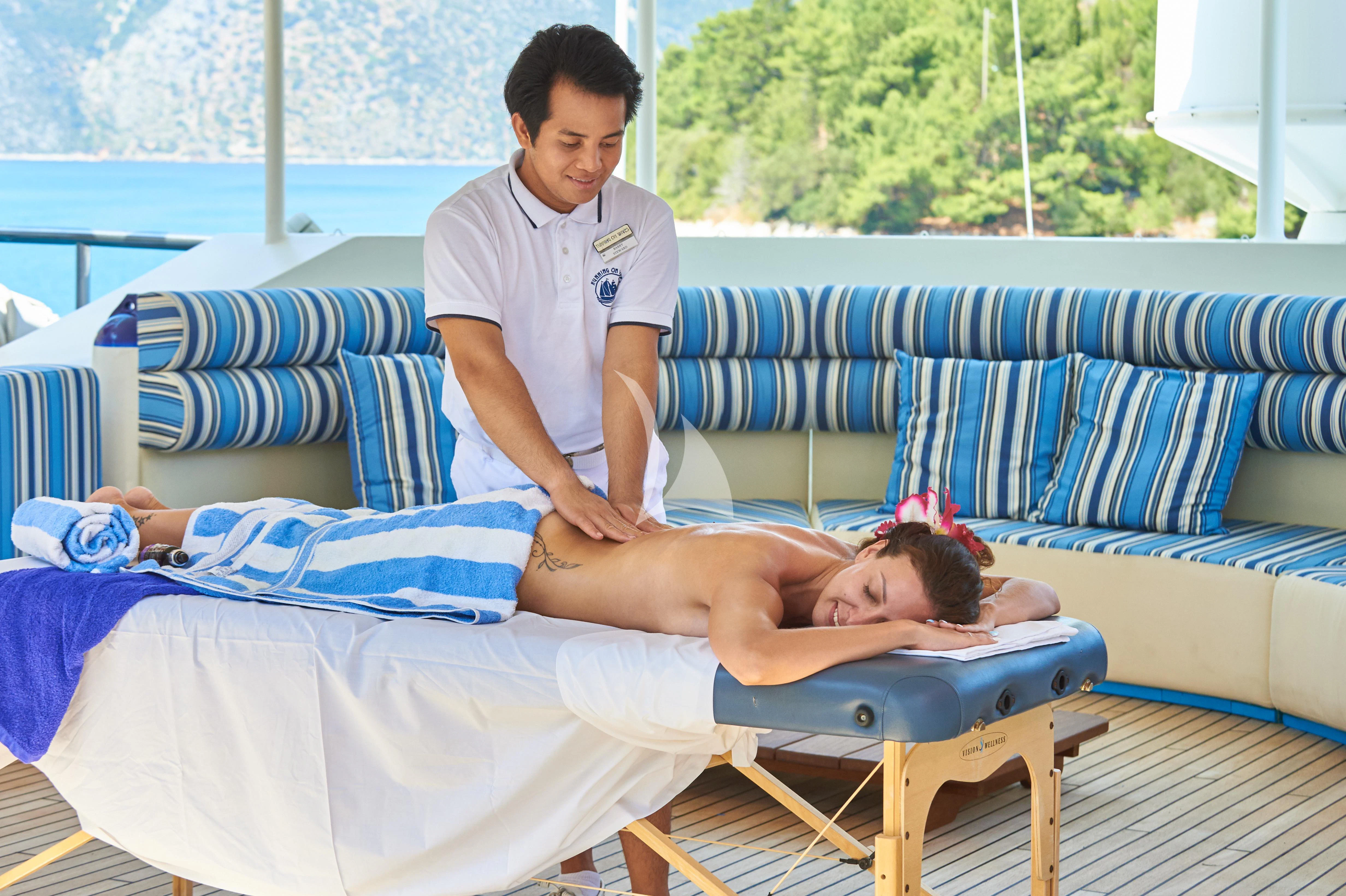 a man and a woman lying on a bed aboard RUNNING ON WAVES Yacht for Charter