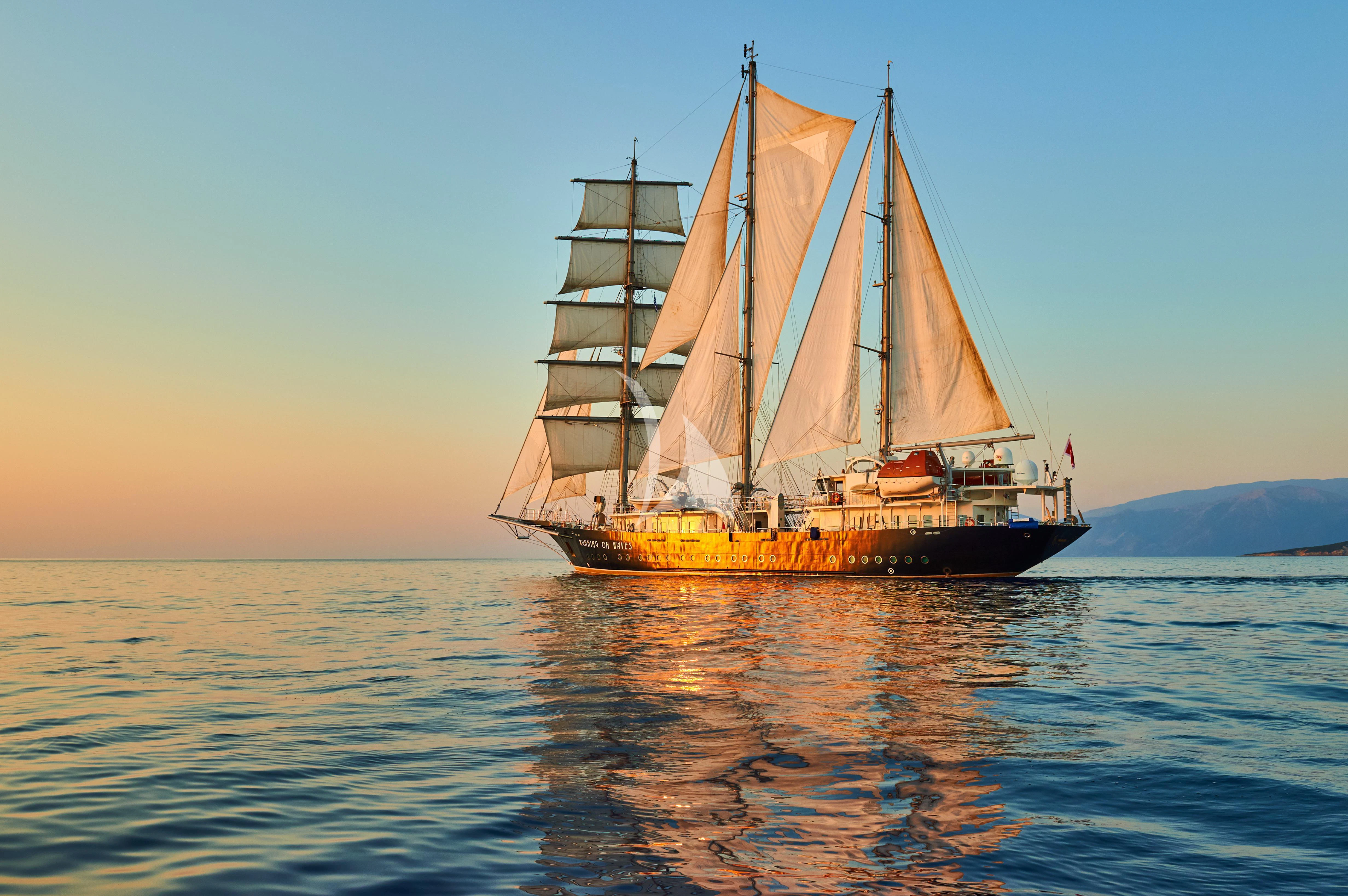 a sailboat in the water aboard RUNNING ON WAVES Yacht for Charter
