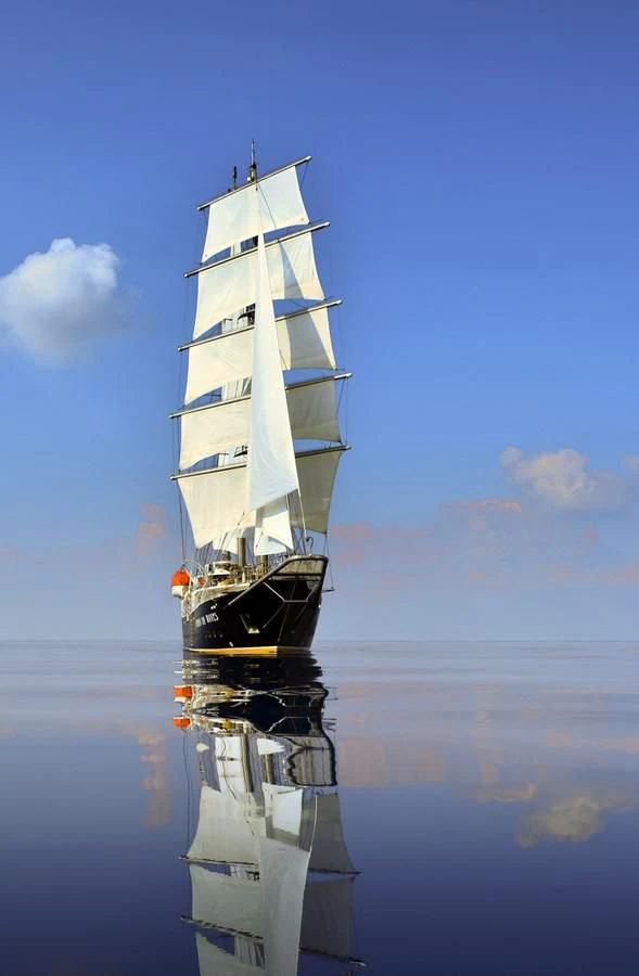 a tall white ship in the water aboard RUNNING ON WAVES Yacht for Charter