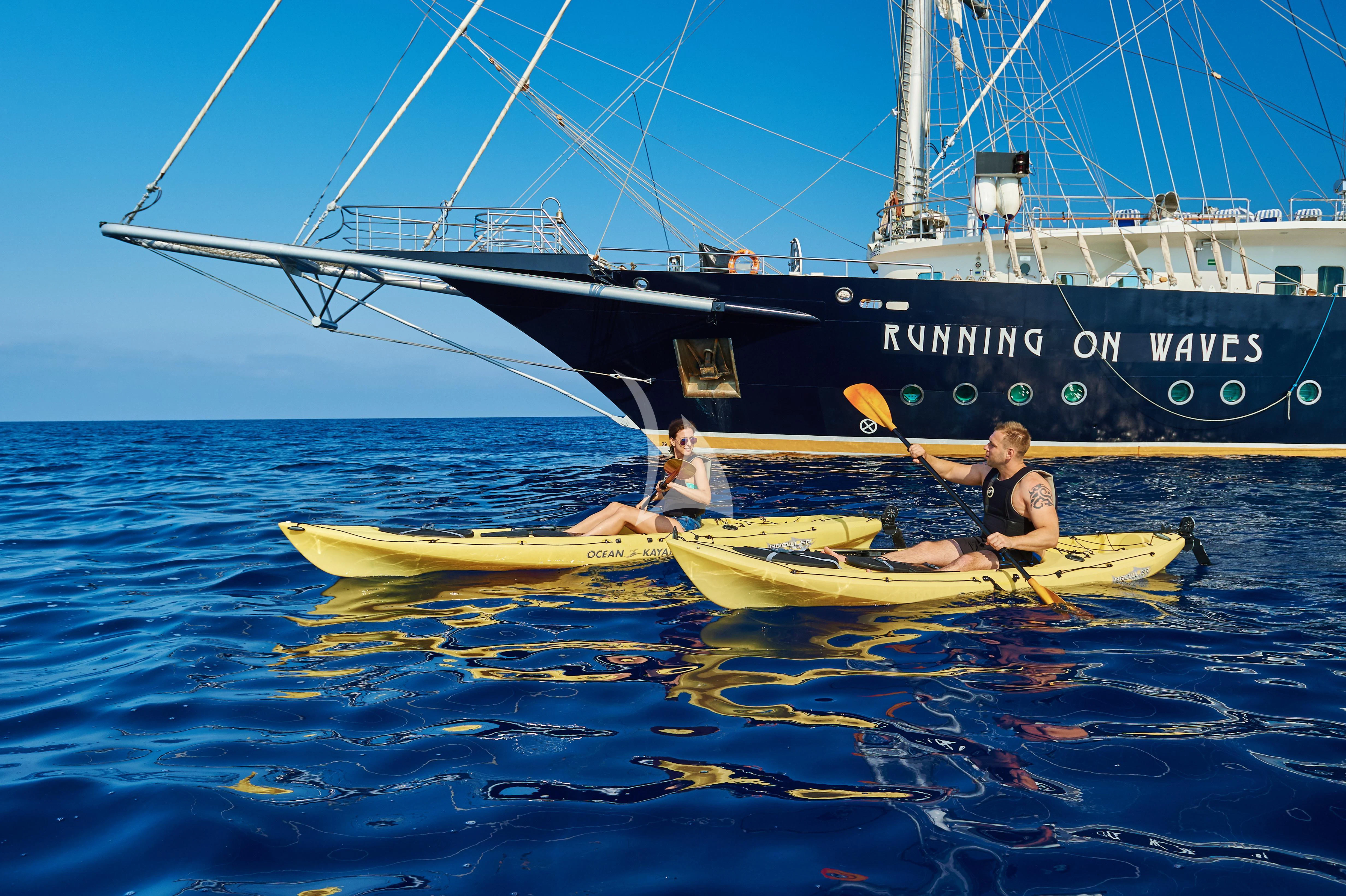 a couple of people in a boat aboard RUNNING ON WAVES Yacht for Charter