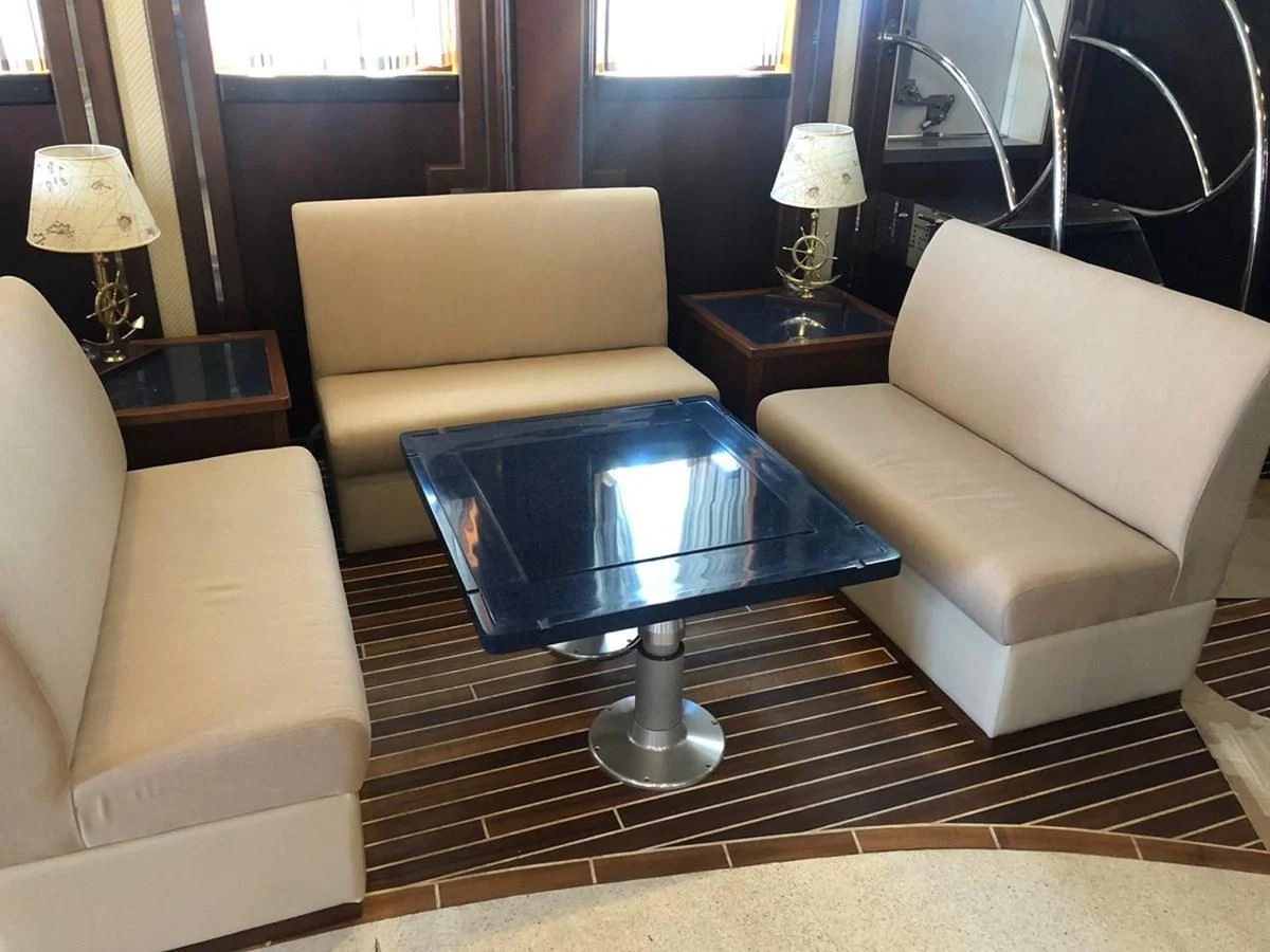 a living room with a coffee table aboard RUNNING ON WAVES Yacht for Charter