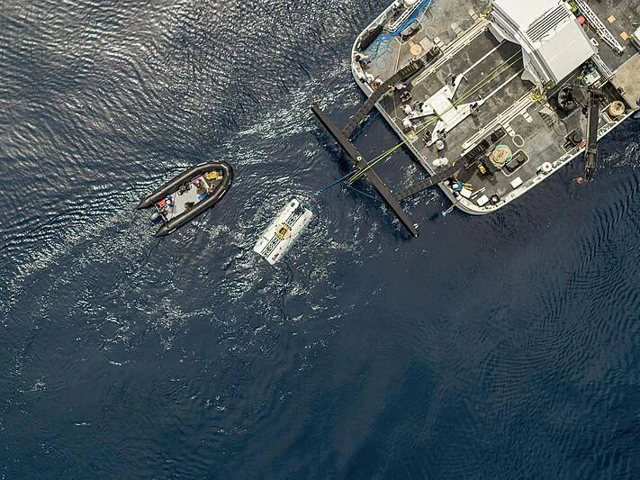 a helicopter flying over a body of water aboard DAGON Yacht for Sale