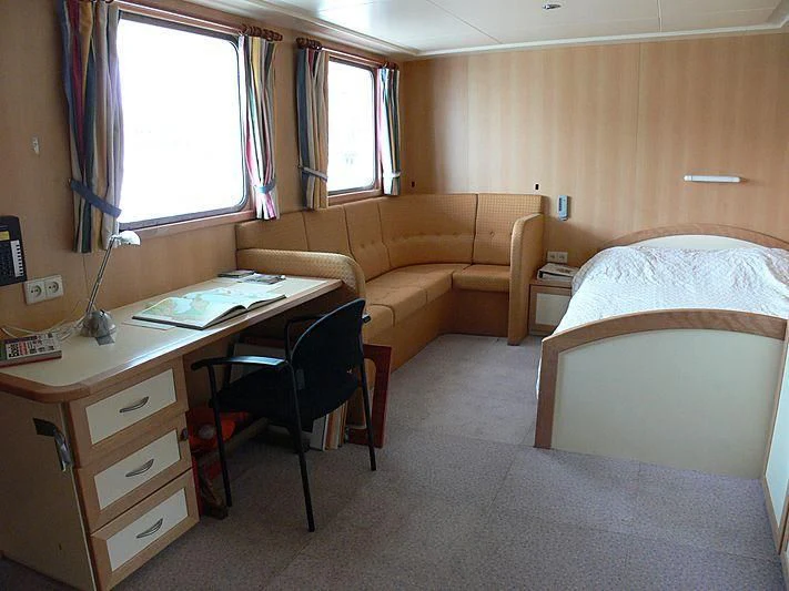a bedroom with a desk and a bed aboard 54M SUPERYACHT HULL Yacht for Sale