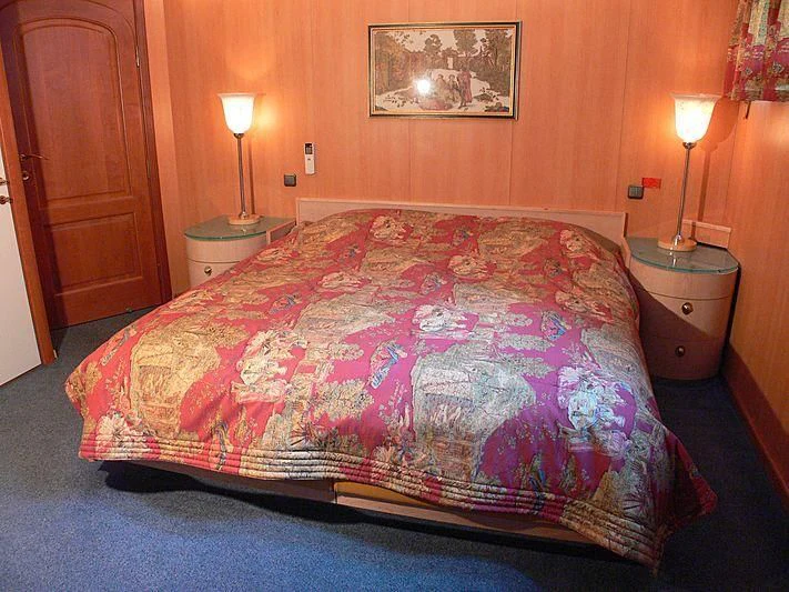 a bed with a floral comforter aboard 54M SUPERYACHT HULL Yacht for Sale
