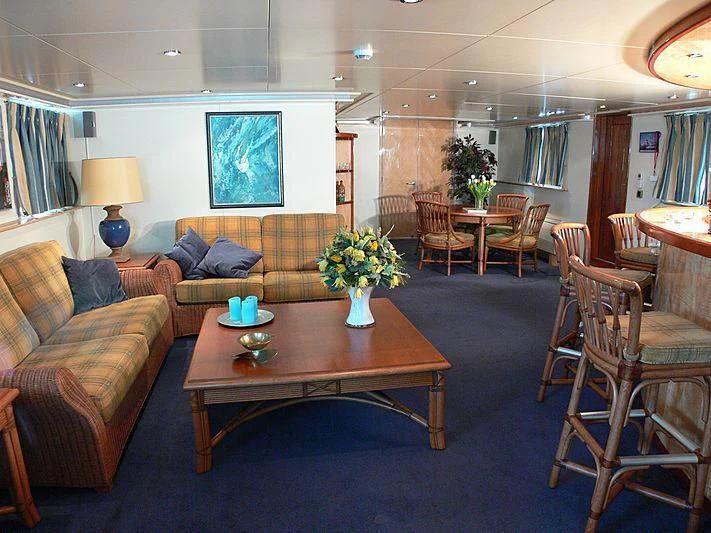 a living room with a table and chairs aboard 54M SUPERYACHT HULL Yacht for Sale