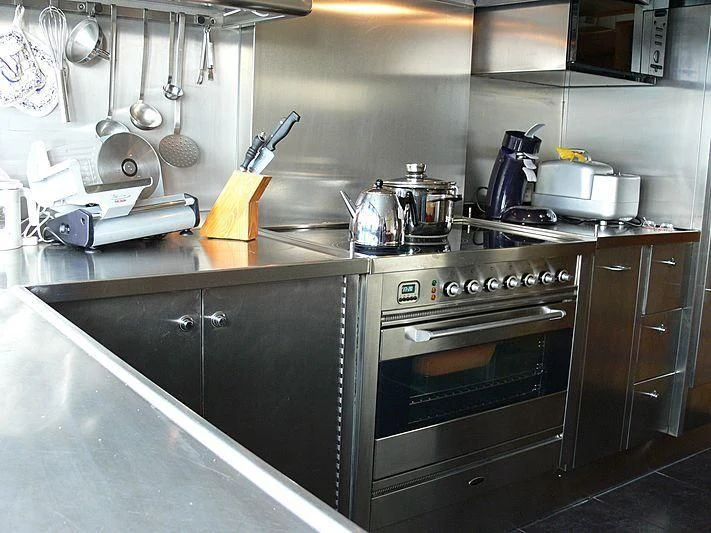 a kitchen with a stove and a tea kettle on the stove aboard 54M SUPERYACHT HULL Yacht for Sale