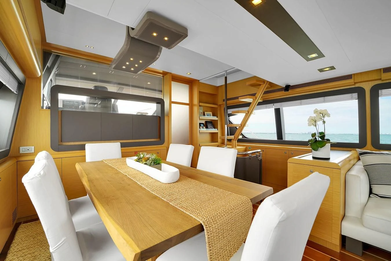 a room with tables and chairs aboard FERRETTI YACHTS F800 Yacht for Sale