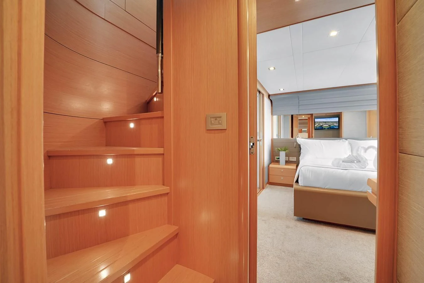 a room with a bed and a wood door aboard FERRETTI YACHTS F800 Yacht for Sale