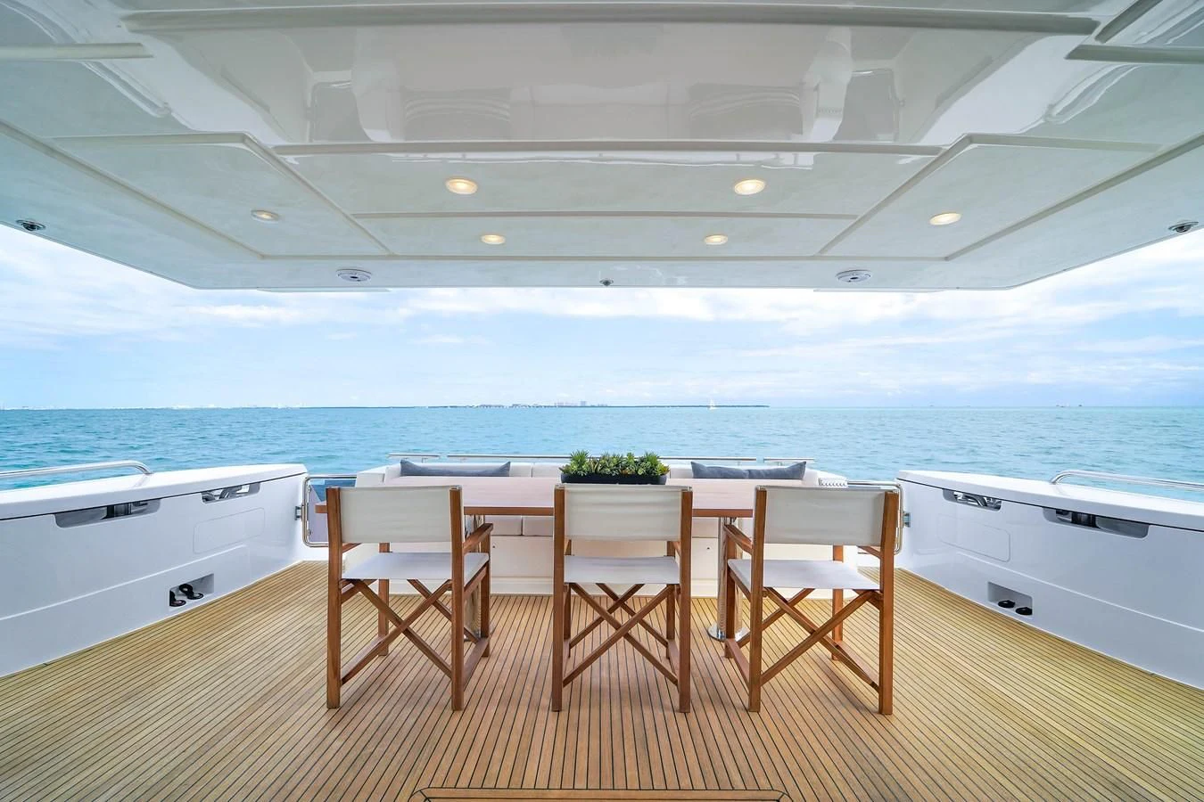 a large white kitchen with a table and chairs aboard FERRETTI YACHTS F800 Yacht for Sale