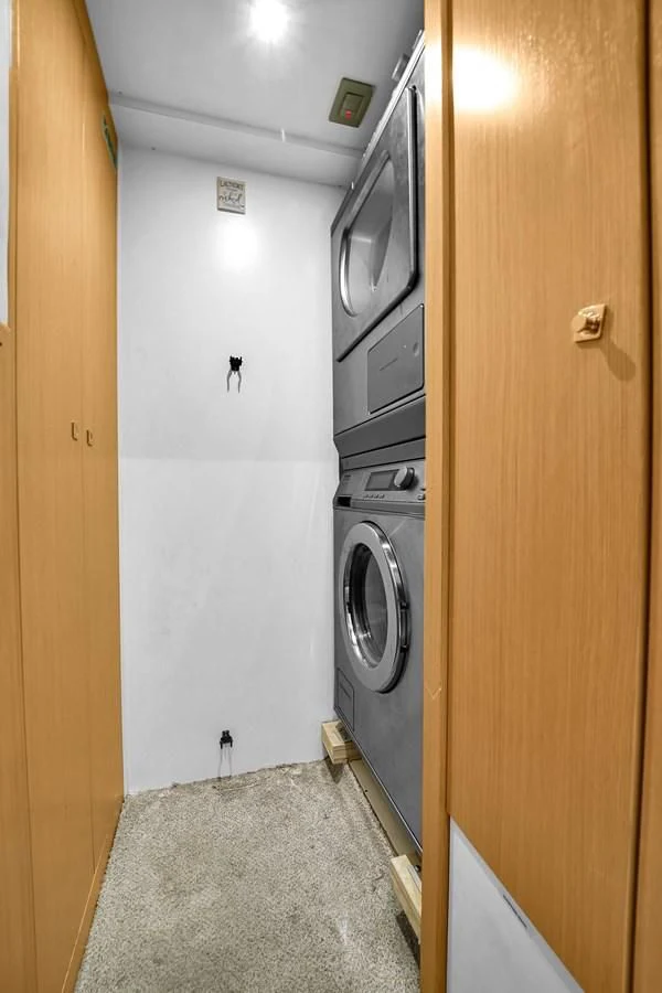 a small kitchen with a washing machine aboard FERRETTI YACHTS F800 Yacht for Sale