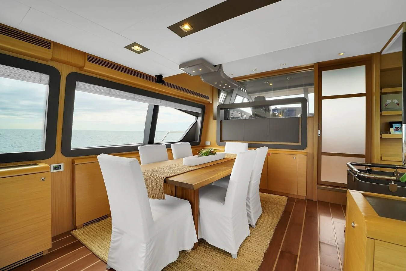 a room with a table and chairs aboard FERRETTI YACHTS F800 Yacht for Sale