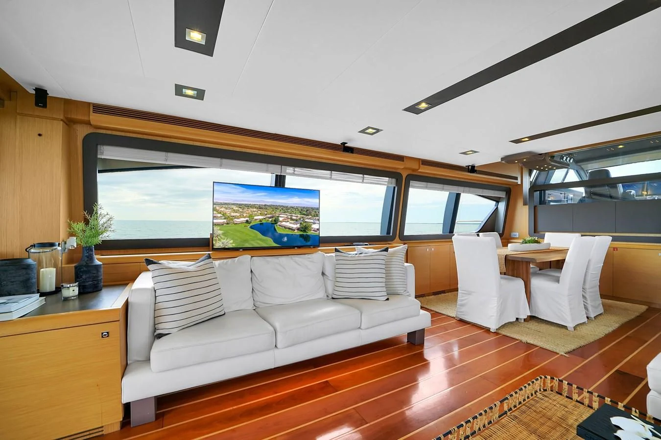 a living room with a large screen aboard FERRETTI YACHTS F800 Yacht for Sale