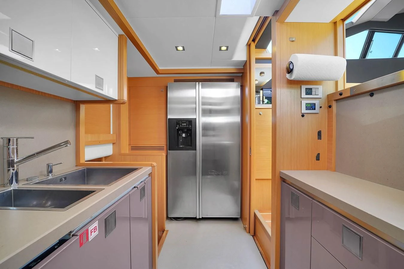 a kitchen with a stainless steel refrigerator aboard FERRETTI YACHTS F800 Yacht for Sale