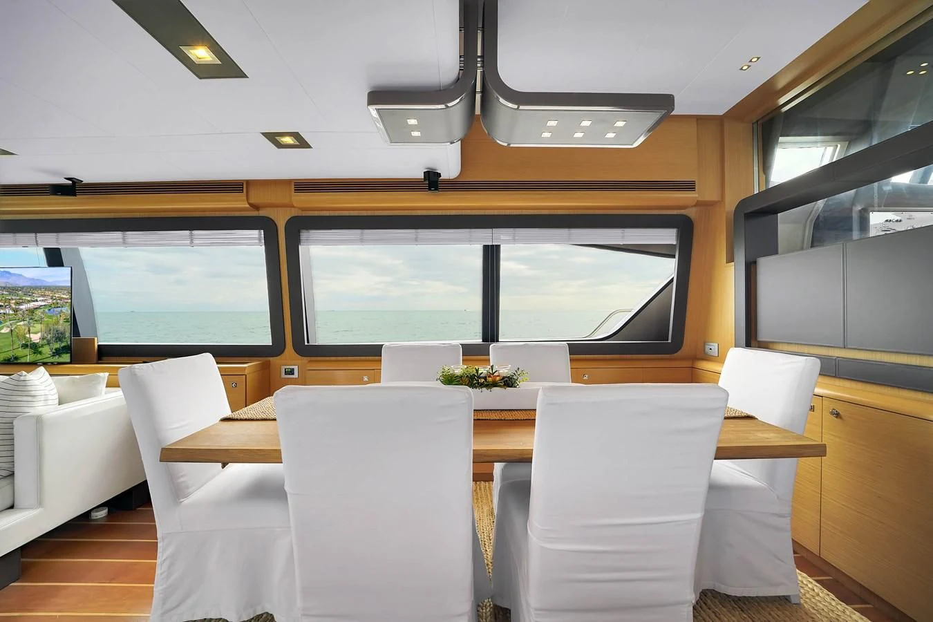 a room with a table and chairs aboard FERRETTI YACHTS F800 Yacht for Sale