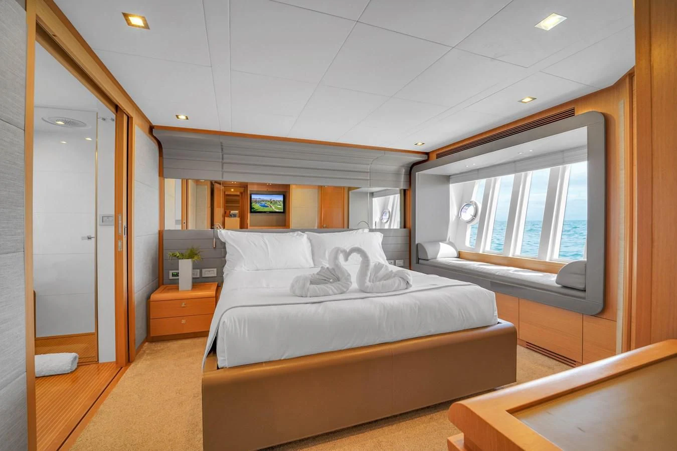 a bedroom with a bed and a window aboard FERRETTI YACHTS F800 Yacht for Sale