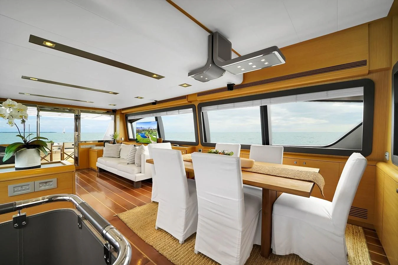 a room with a table chairs and a large window aboard FERRETTI YACHTS F800 Yacht for Sale