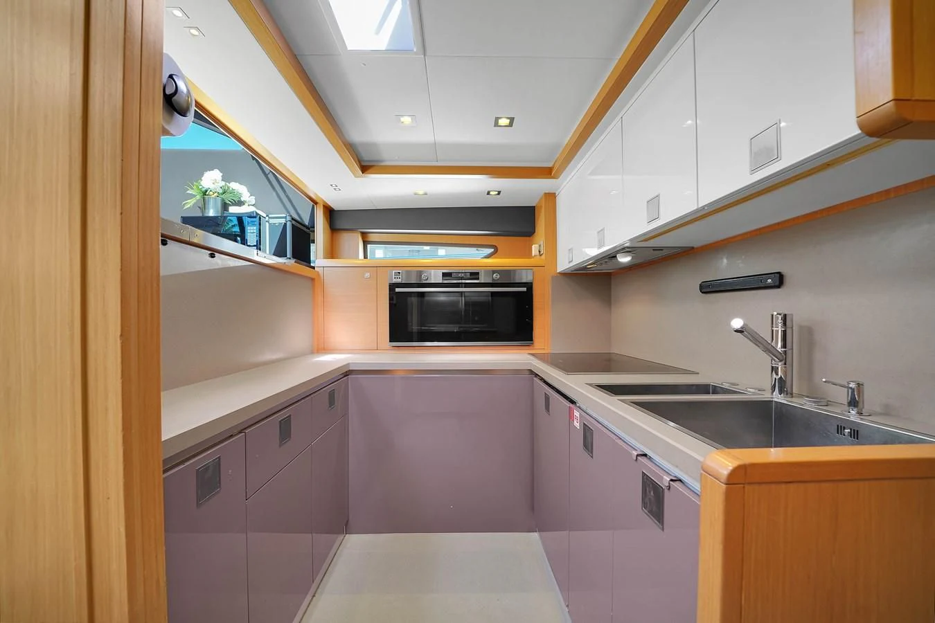 a kitchen with pink cabinets aboard FERRETTI YACHTS F800 Yacht for Sale