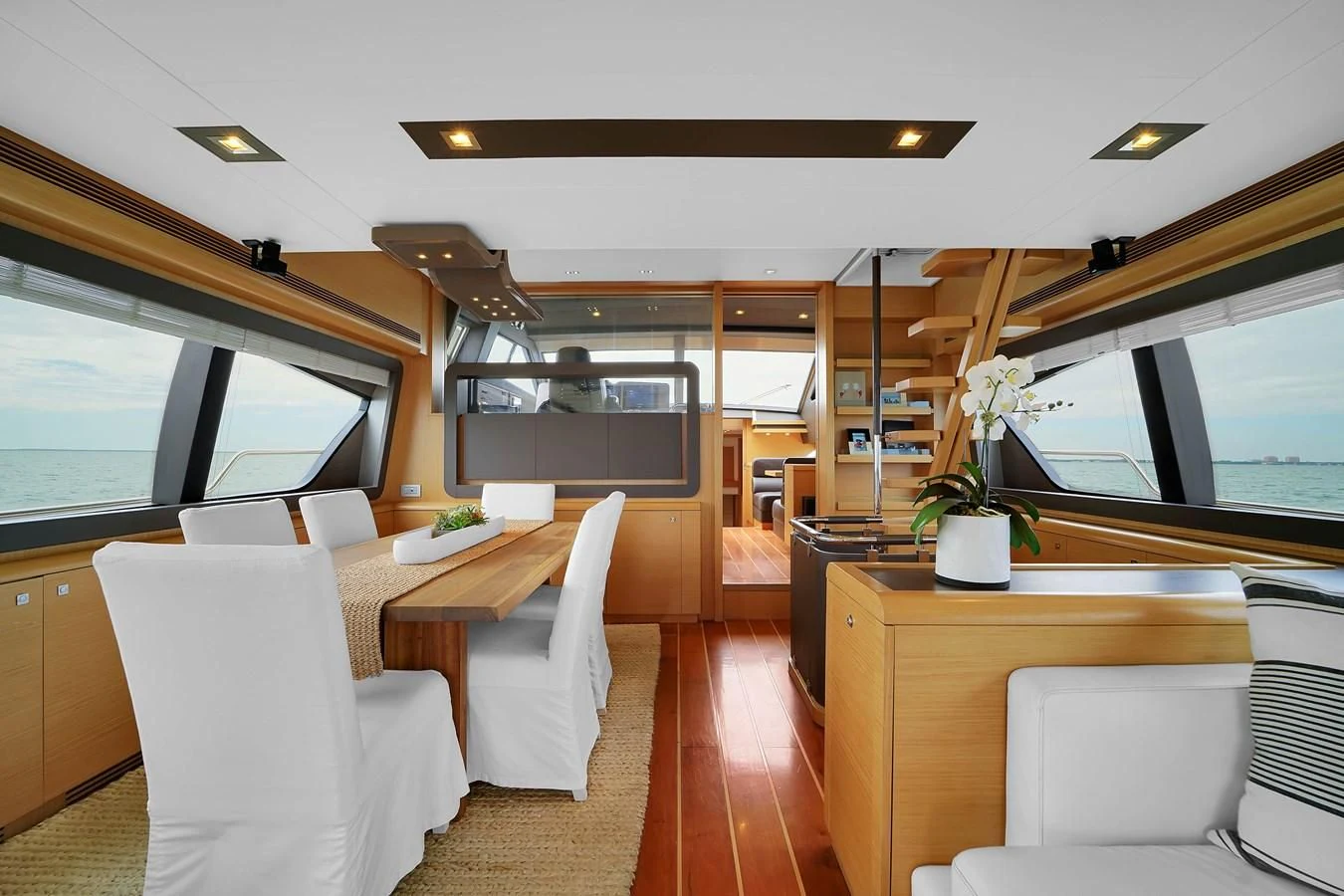 a living room with a wood floor aboard FERRETTI YACHTS F800 Yacht for Sale