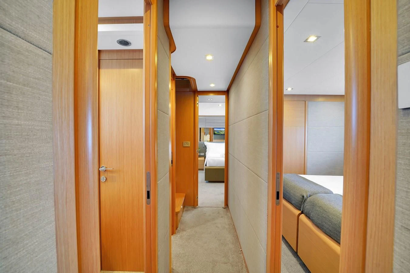 a hallway with a bed and a door aboard FERRETTI YACHTS F800 Yacht for Sale