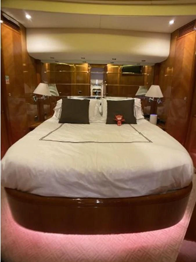 a bed with a pink comforter aboard 85 AZIMUT ULTIMATE Yacht for Sale