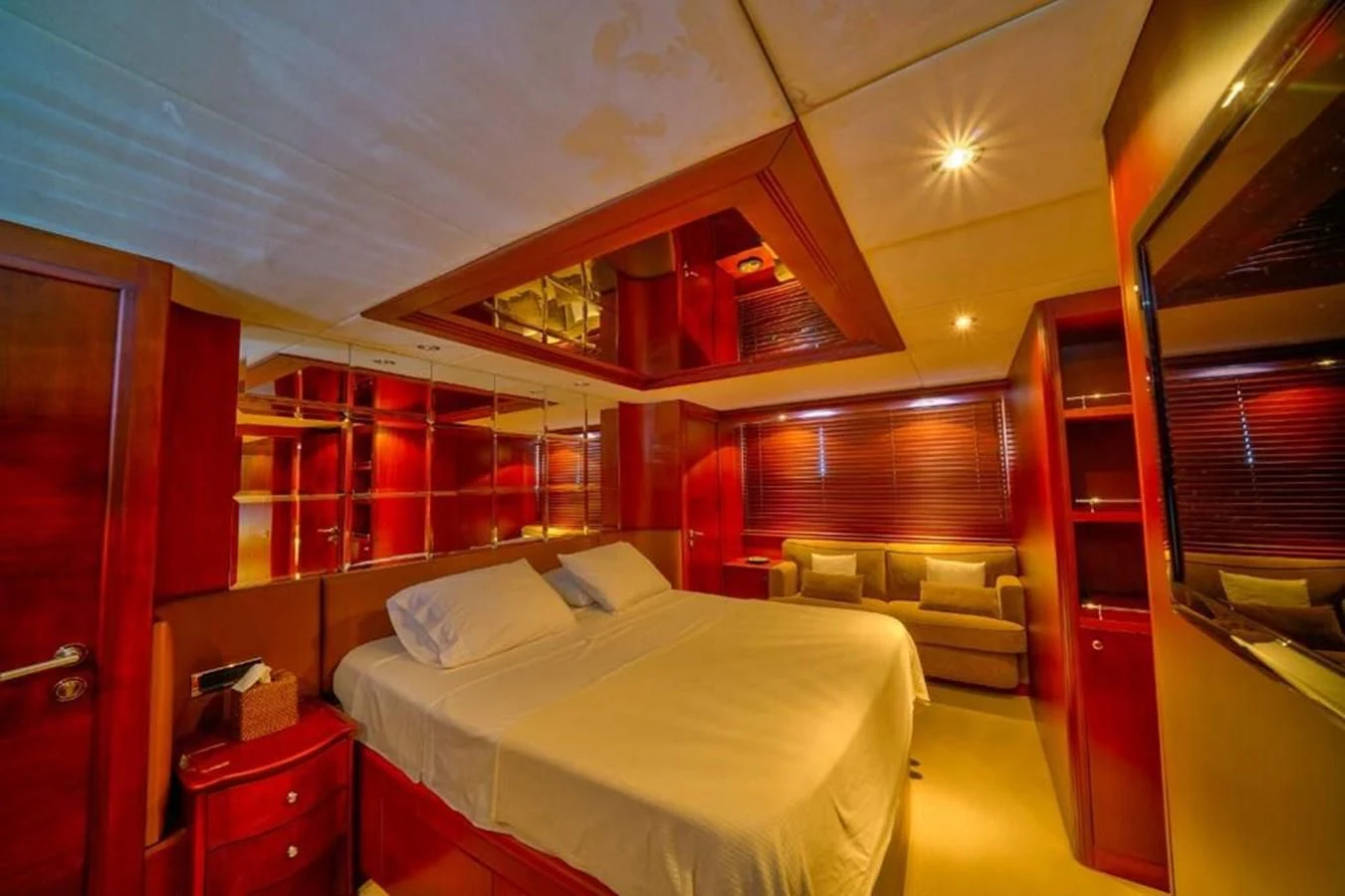 a room with a bed and a couch aboard DANIELA Yacht for Sale