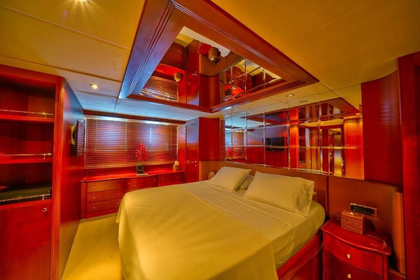 a bedroom with a bed and a desk aboard DANIELA Yacht for Sale