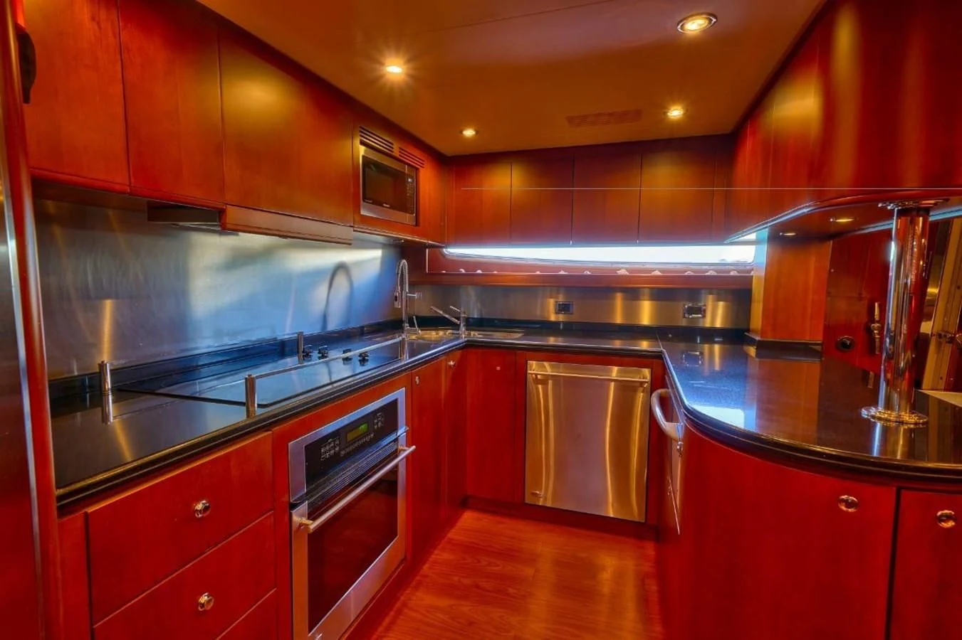 a kitchen with red cabinets aboard DANIELA Yacht for Sale